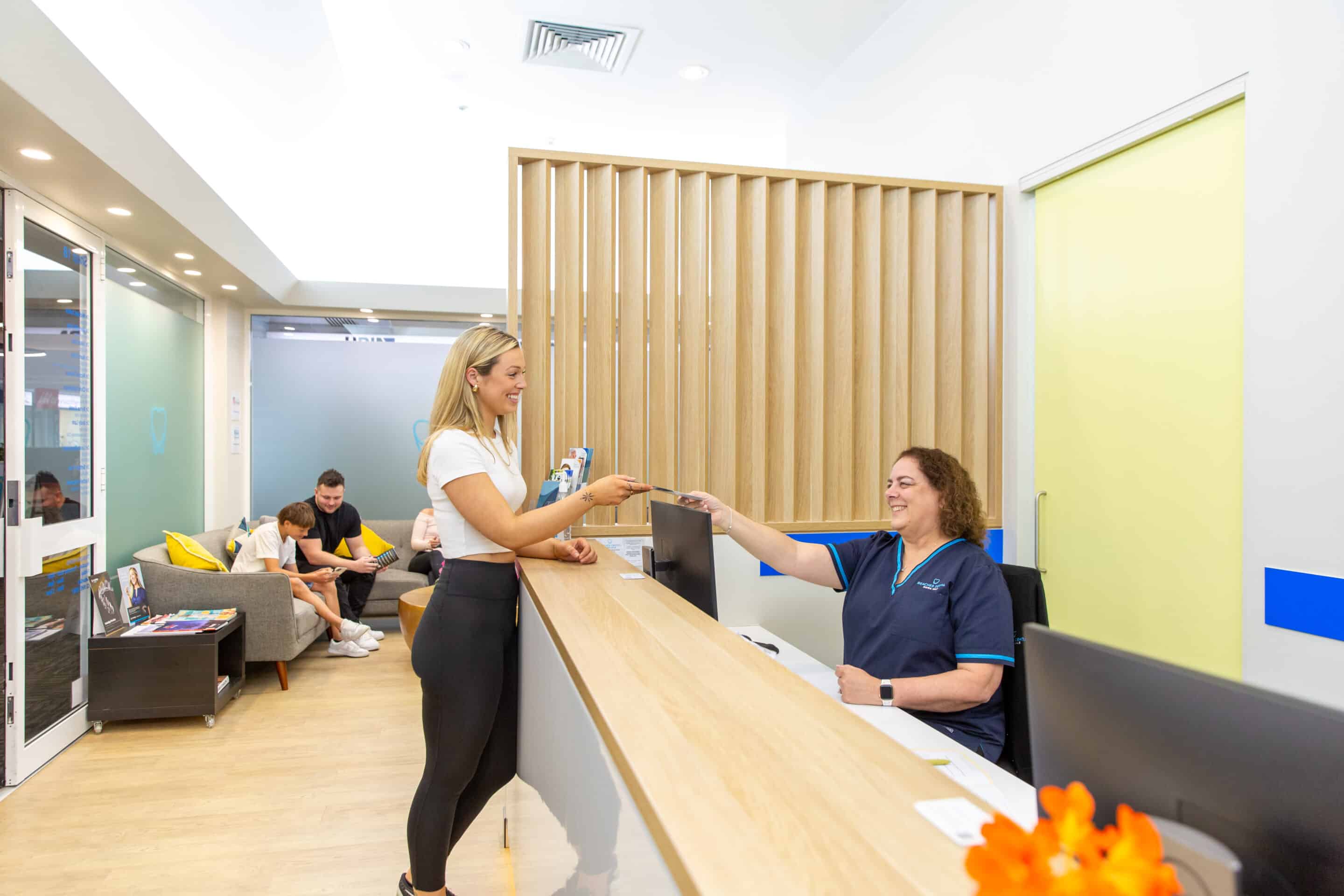 A dental patient at Beaches Dental Mona Vale reception.