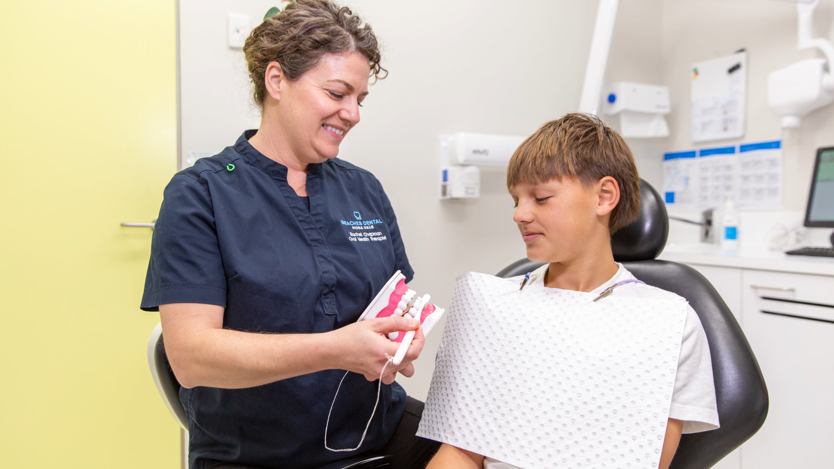 Dentist having fun with children in dental office.