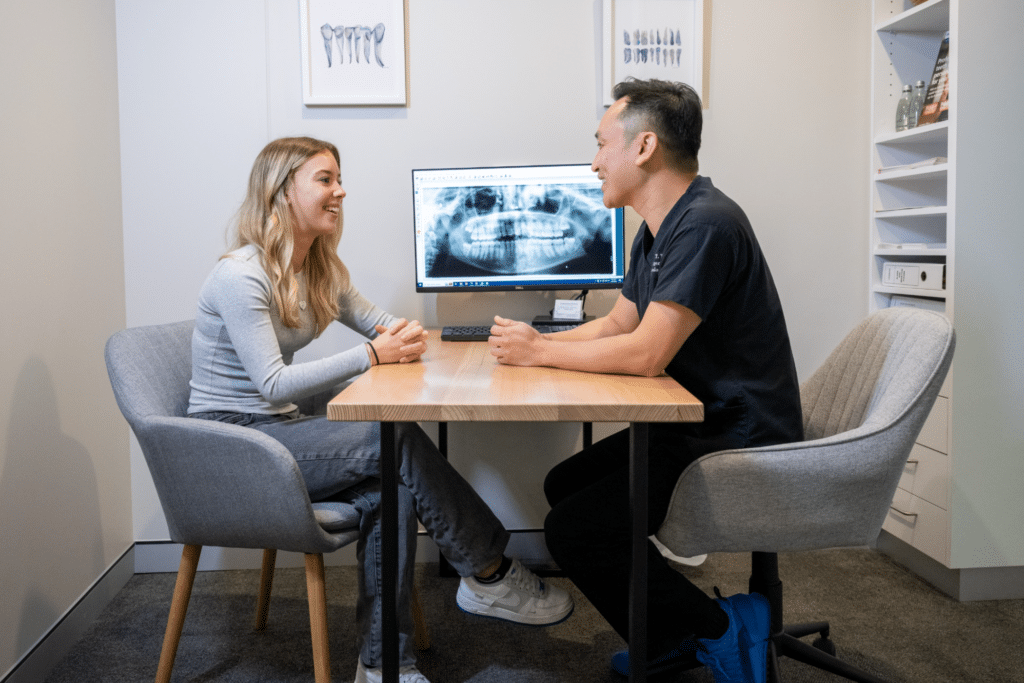 A woman discussing the right night guard for her during a consultation with her dentist