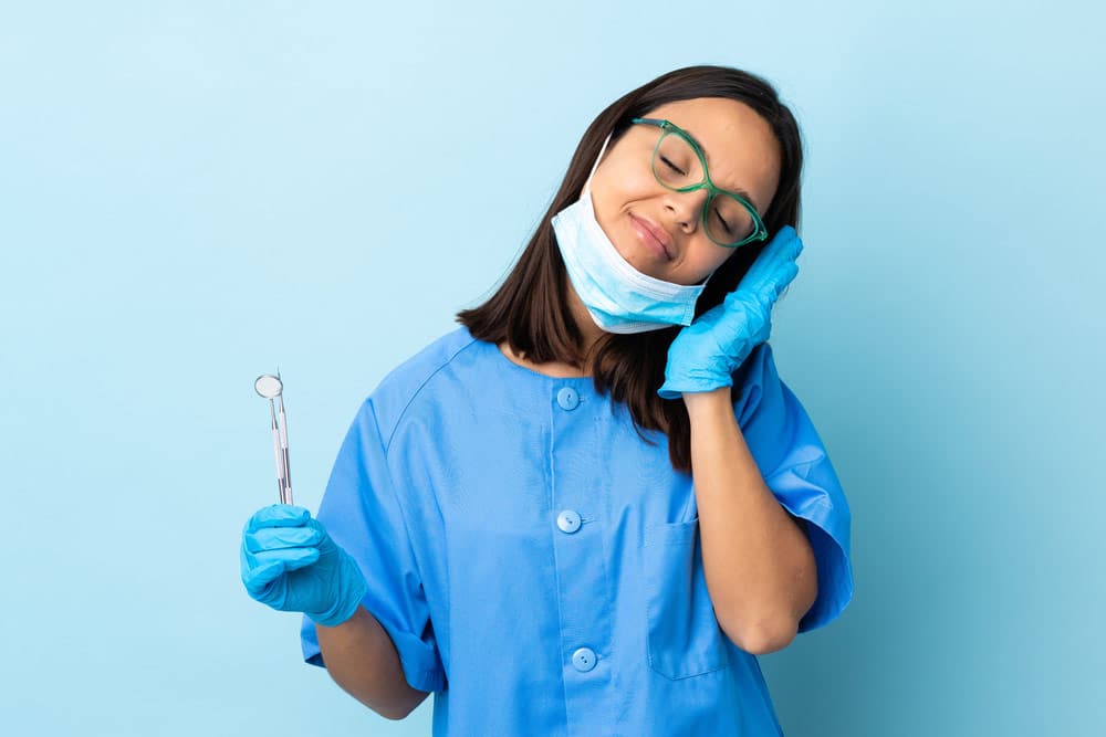 a dentist resting her hand at the back of her left hand to signify sleep dentistry