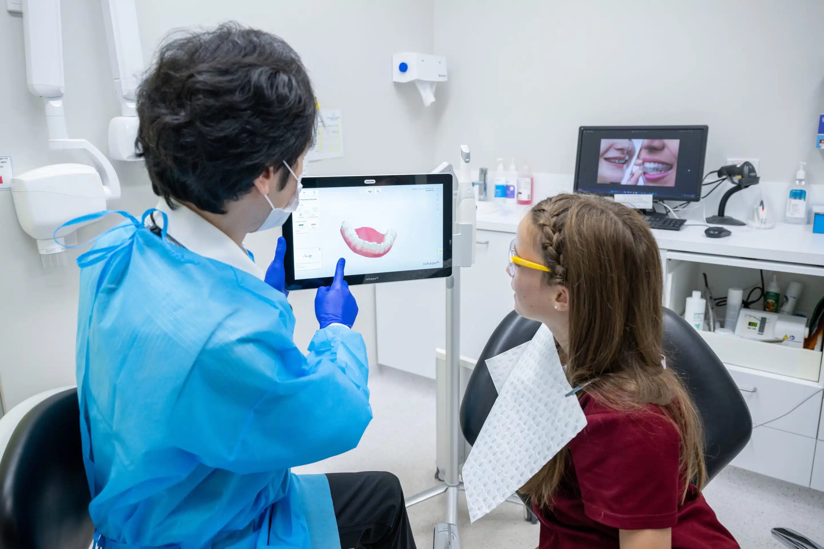 Dentist showing a young patient a 3D digital scan of teeth for orthodontic planning at Beaches Dental Mona Vale<br />