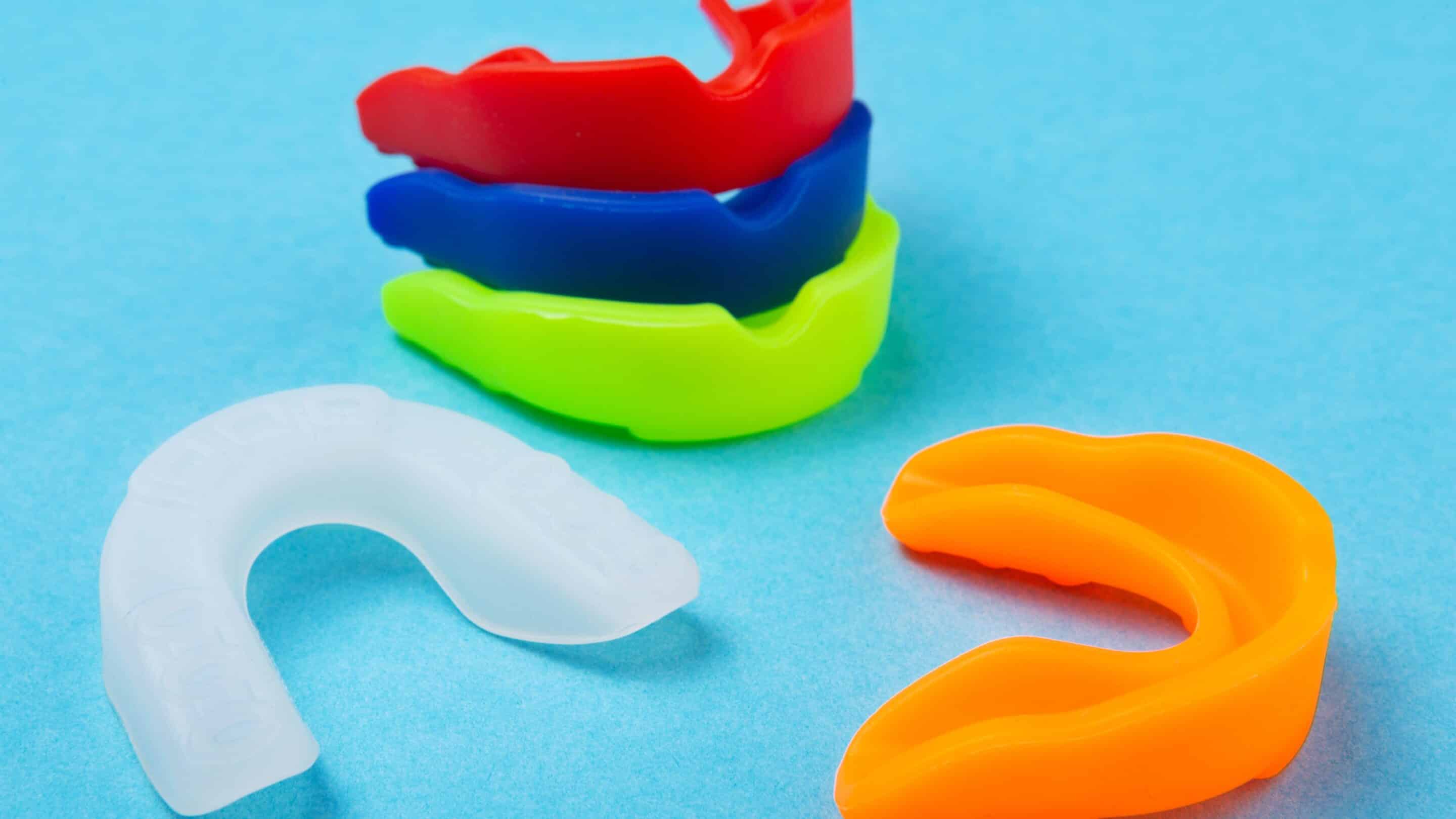 Children's dental mouthguards on a blue background